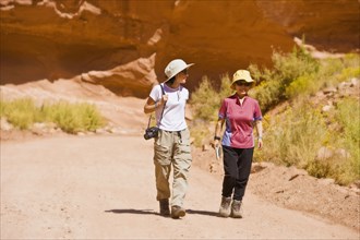 Asian women walking in desert