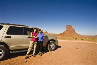 Asian mother and daughter in desert