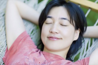 Asian woman sleeping in  hammock