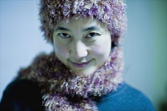 Asian woman in knitted hat and scarf