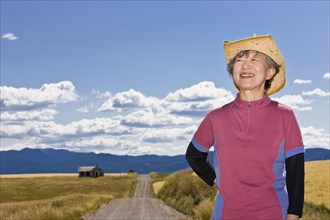 Senior Japanese woman on dirt road in countryside