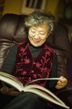 Senior Japanese woman reading book