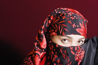Mixed race woman wearing headscarf