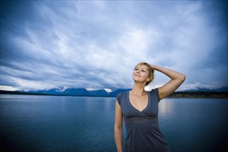 Caucasian woman standing near lake