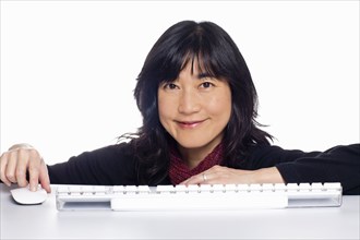 Japanese woman using computer keyboard and mouse