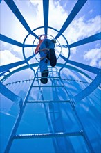 Man climbing water tower ladder