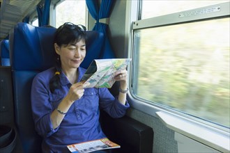 Japanese woman reading roadmap on train