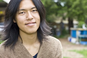 Japanese man smiling outdoors