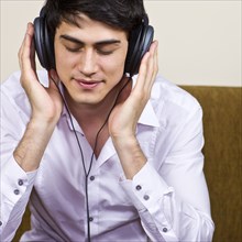 Mixed race man listening to headphones