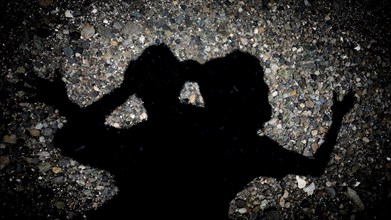 Silhouette of Japanese couple on pavement