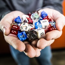Hands holding variety of dice