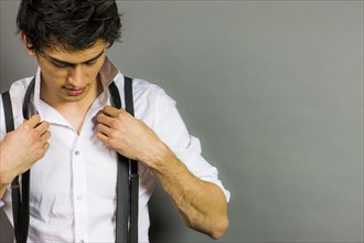 Mixed Race man tying necktie