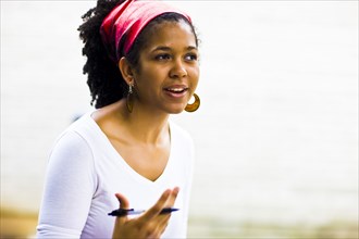 Mixed Race woman gesturing with pen