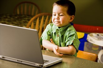 Mixed Race boy using laptop