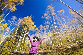 Japanese woman celebrating in forest