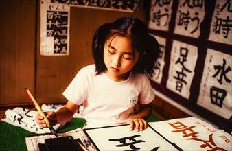 Girl drawing Japanese script