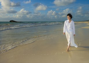 Japanese woman walking on beach