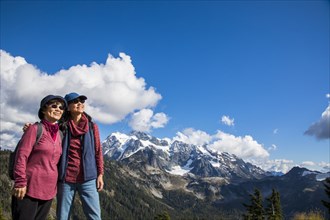 Older Japanese mother and daughter standing near mountain