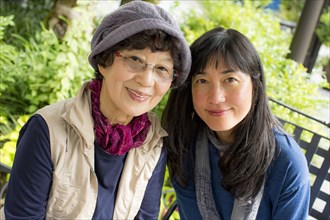 Portrait of smiling older Japanese mother and daughter