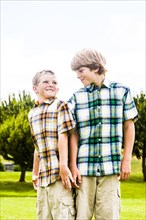 Smiling Caucasian brothers wearing plaid shirts