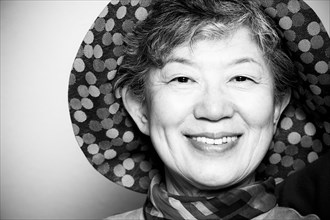 Portrait of smiling Japanese woman wearing hat