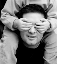 Son covering eyes of father