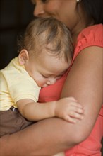 Mother holding sleeping child