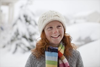 Smiling Caucasian girl standing in snow