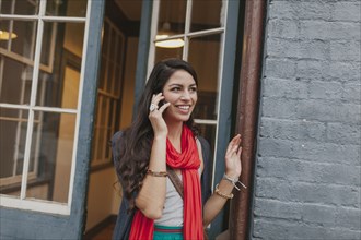 Mixed race woman talking on cell phone