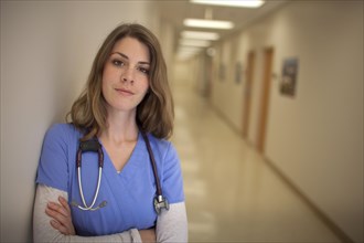 Caucasian nurse wearing stethoscope in hospital