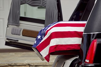 American flag over casket at military funeral