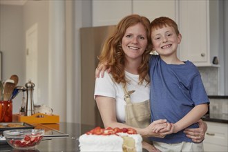 Caucasian mother and son smiling in kitchen