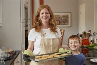 Caucasian mother and son baking cookies in kitchen