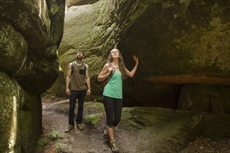Caucasian couple exploring cave