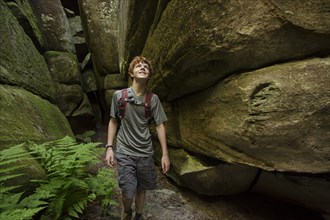 Caucasian teenage boy exploring cave