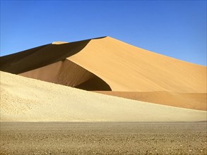 Sand dunes under blue sky in Namib-Naukluft National Park