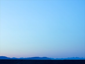Silhouette of mountain range under blue sky
