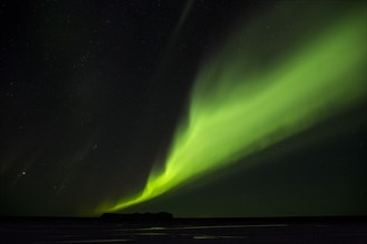 Northern Lights glowing green in night sky