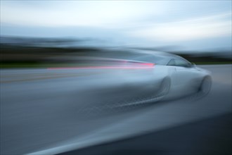 Blurred view of car driving on road