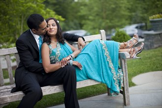 Indian man kissing wife in traditional clothing