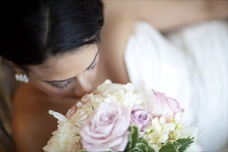 Egyptian bride smelling bouquet
