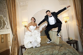 Egyptian bride jumping on bed