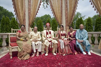 Indian bride and groom with family in traditional clothing