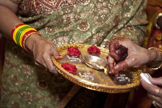 Indian woman holding tray and match
