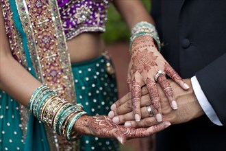 Indian wedding couple with ornate hand decorations