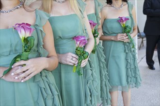 Bridesmaids holding bouquets of flowers