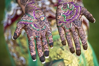 Close up of hands with intricate henna design