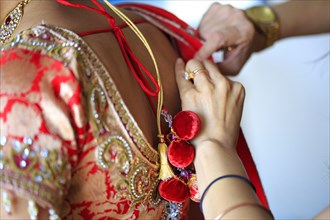 Dressmaker adjusting traditional Indian dress