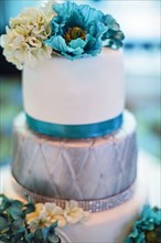 Blue and silver wedding cake with flowers