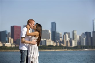 Couple kissing by Chicago skyline